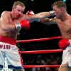 Arturo Gatti and Micky Ward captured mid-exchange, throwing punches with intense focus, in a closely contested boxing match.