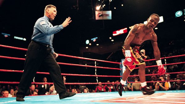 Zab Judah attempting to rise, looking disoriented, after a knockdown by Kostya Tszyu, as referee Jay Nady counts