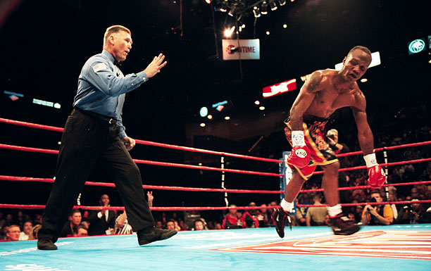Zab Judah attempting to rise, looking disoriented, after a knockdown by Kostya Tszyu, as referee Jay Nady counts