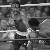 Wilfred Benitez, with blood streaming down his face, delivering a punch to a staggered Sugar Ray Leonard during a boxing match.