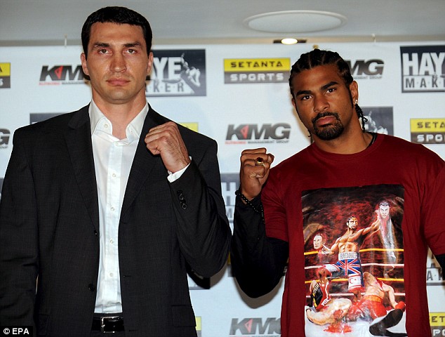 Wladimir Klitschko and David Haye posing before their fight, with Haye wearing his controversial T-shirt that shows him decapitating the Klitschko brothers