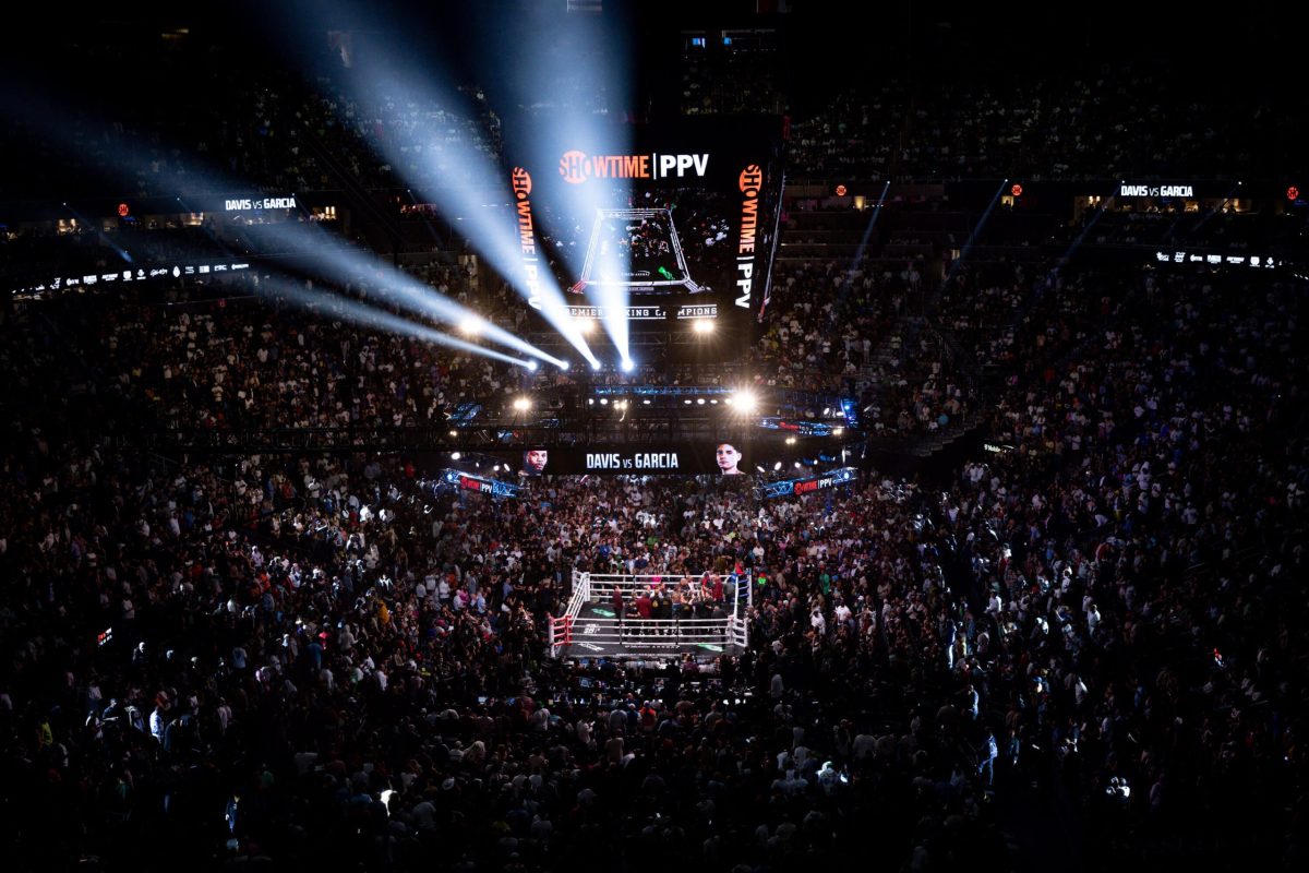 Panoramic shot of the T-Mobile Arena, teeming with excited fans, for the Ryan Garcia vs. Tank Davis fight, capturing the electric atmosphere of the venue.